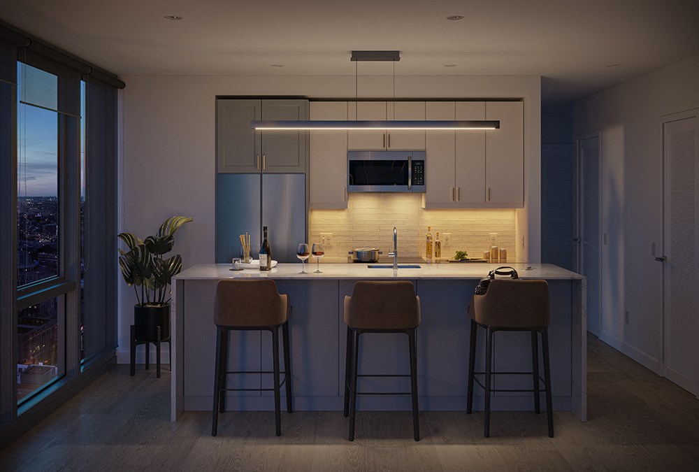 A rendering The Ryland apartment kitchen with an island and stools
