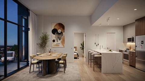 A modern kitchen and dining area with a view of the city at night.