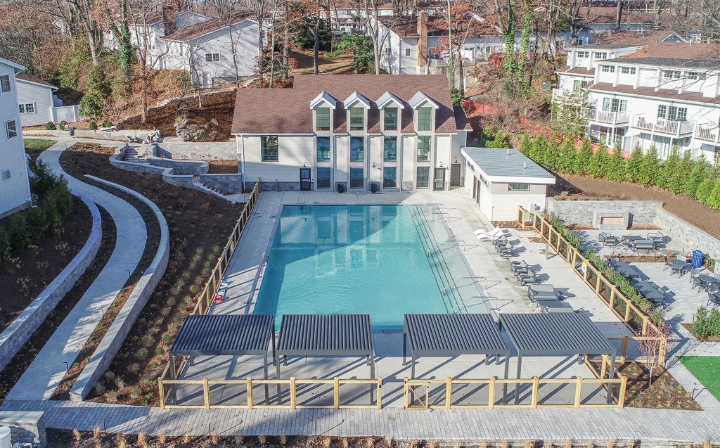 A large house with a pool in the backyard.