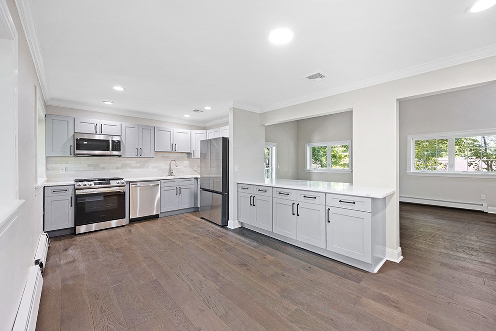 Newly Renovated kitchen with new flooring, quartz countertops, new cabinets, stainless steel appliances
