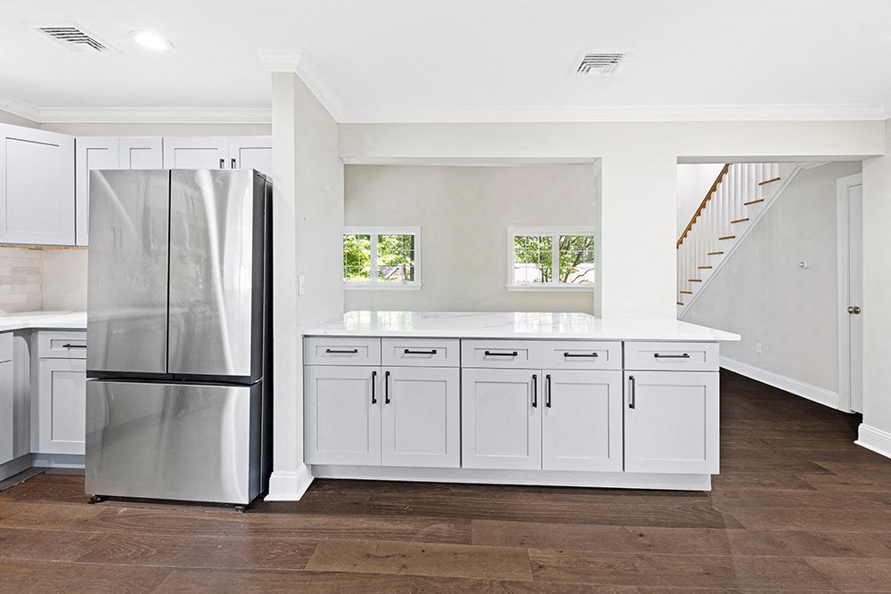 Newly renovated kitchen with new flooring, quartz countertops, new cabinets, stainless steel applianecs