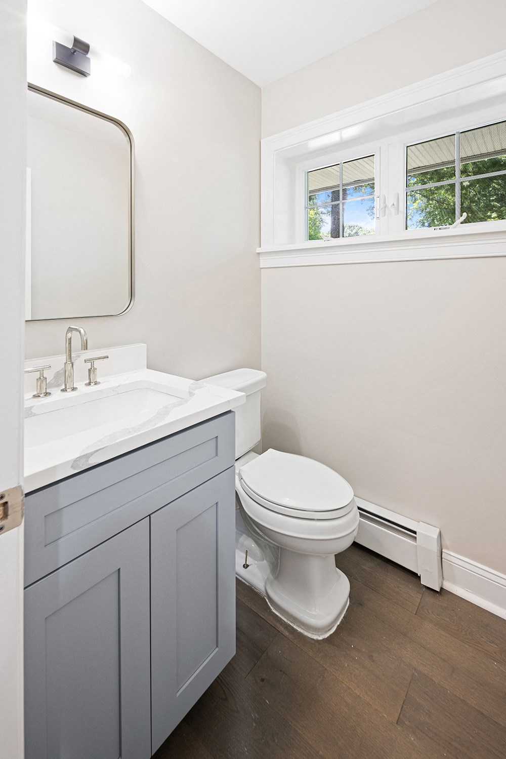 Newly renovated bathroom with new flooring, cabinetry, finishes