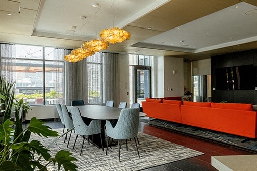 a living room with a table and chairs and a large window