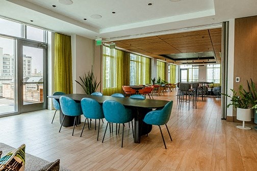 a communal area with tables and chairs in a large room