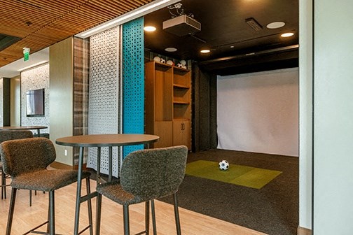 a room with tables and chairs and a soccer ball on the floor