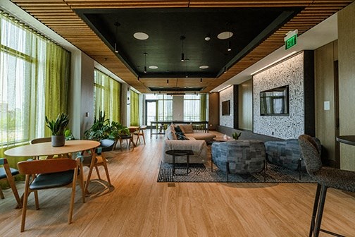 a lobby with a couch and tables and chairs