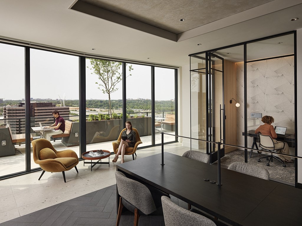 a rendering of a room with glass walls and a table with people sitting in it