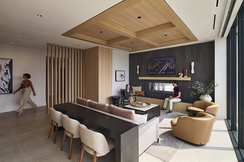 a rendering of a living room with a fireplace and a black dining table