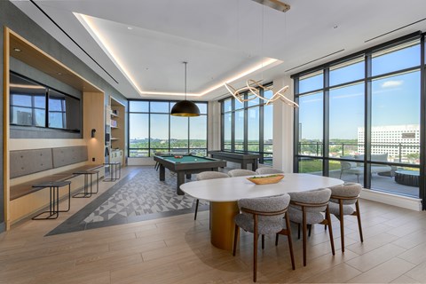 A modern dining room with a large table and chairs.