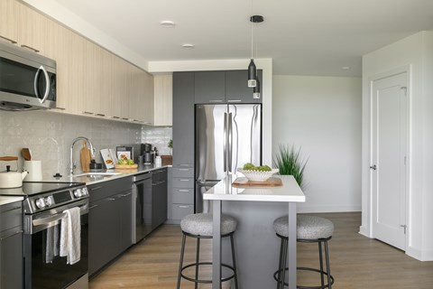 A modern kitchen with a bar stool and a countertop.