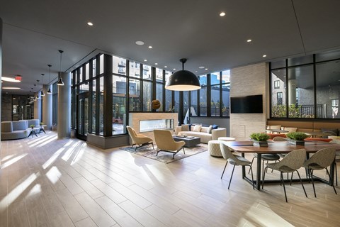 a large room with a fireplace and a table and chairs