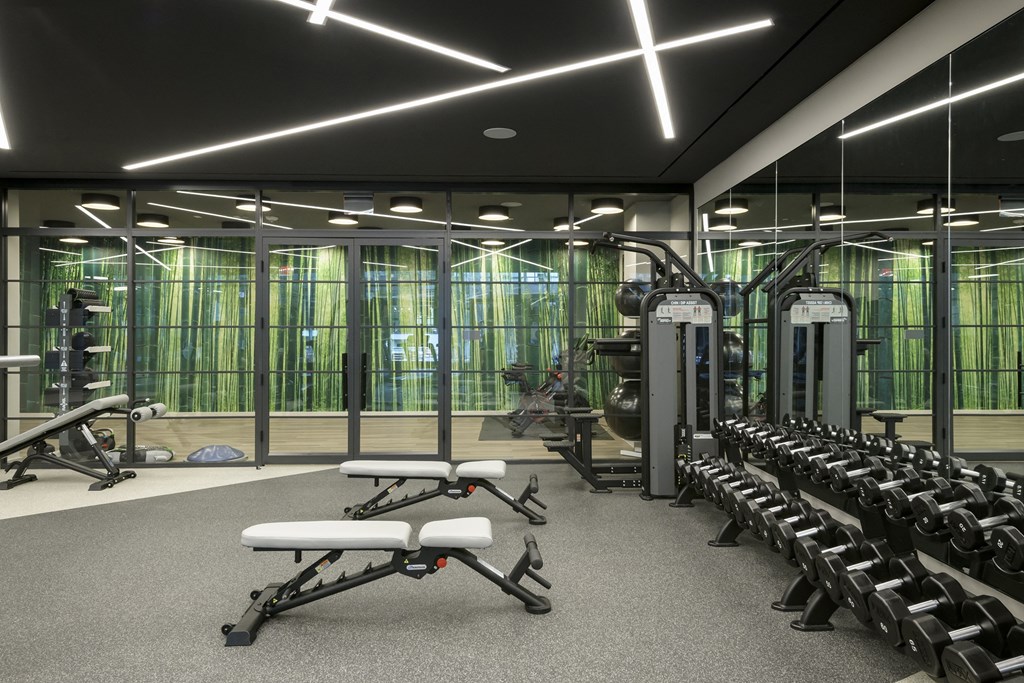 a view of the fitness center with exercise equipment and glass walls
