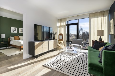 a living room with a couch a coffee table and a tv