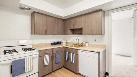 a kitchen with white appliances and wooden cabinets