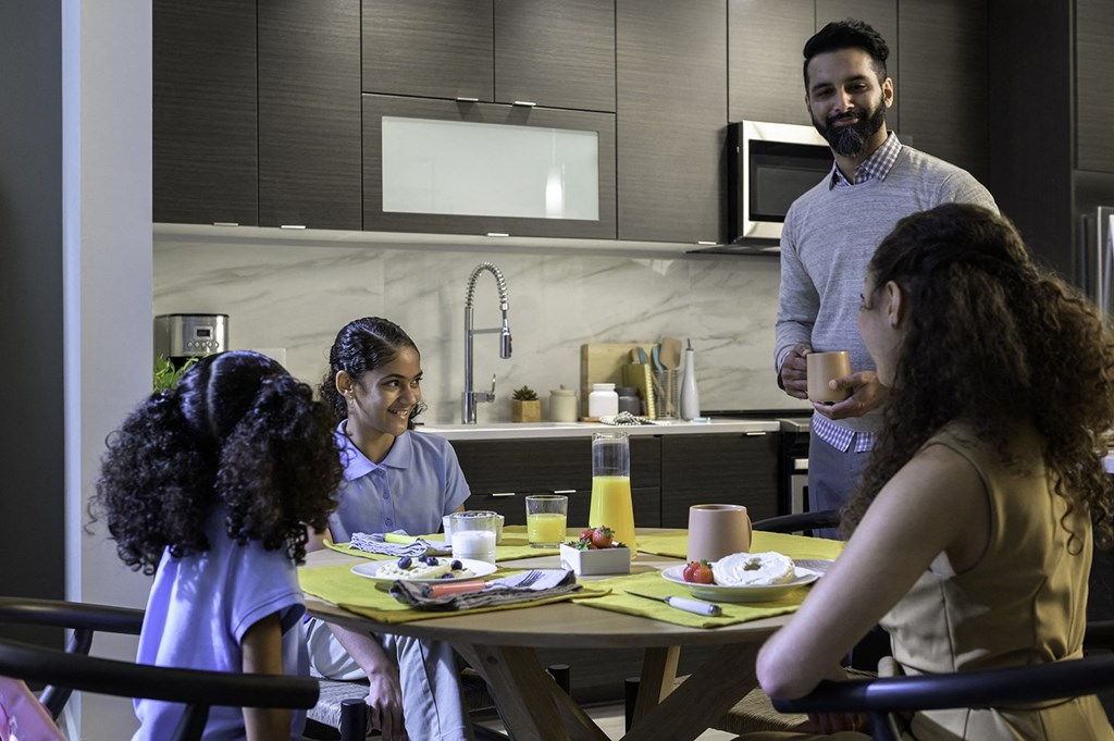 a group of people sitting around a kitchen table at Arrowwood Apartments, North Bethesda