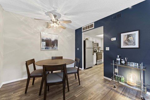 A dining room with a table and chairs.