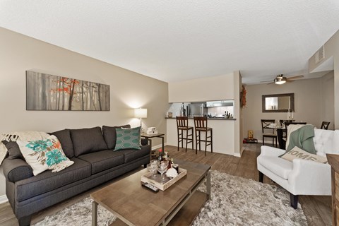 A living room with a grey couch and a coffee table.