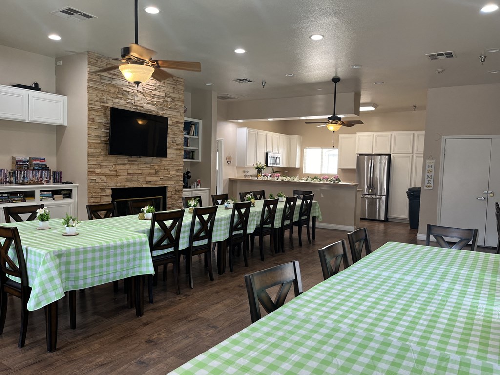 a dining room and kitchen with a table and chairs and a fireplace