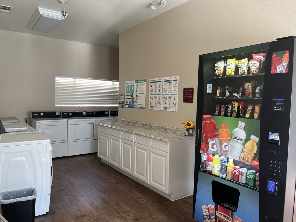 a kitchen with a refrigerator and a counter with a sink and a stove