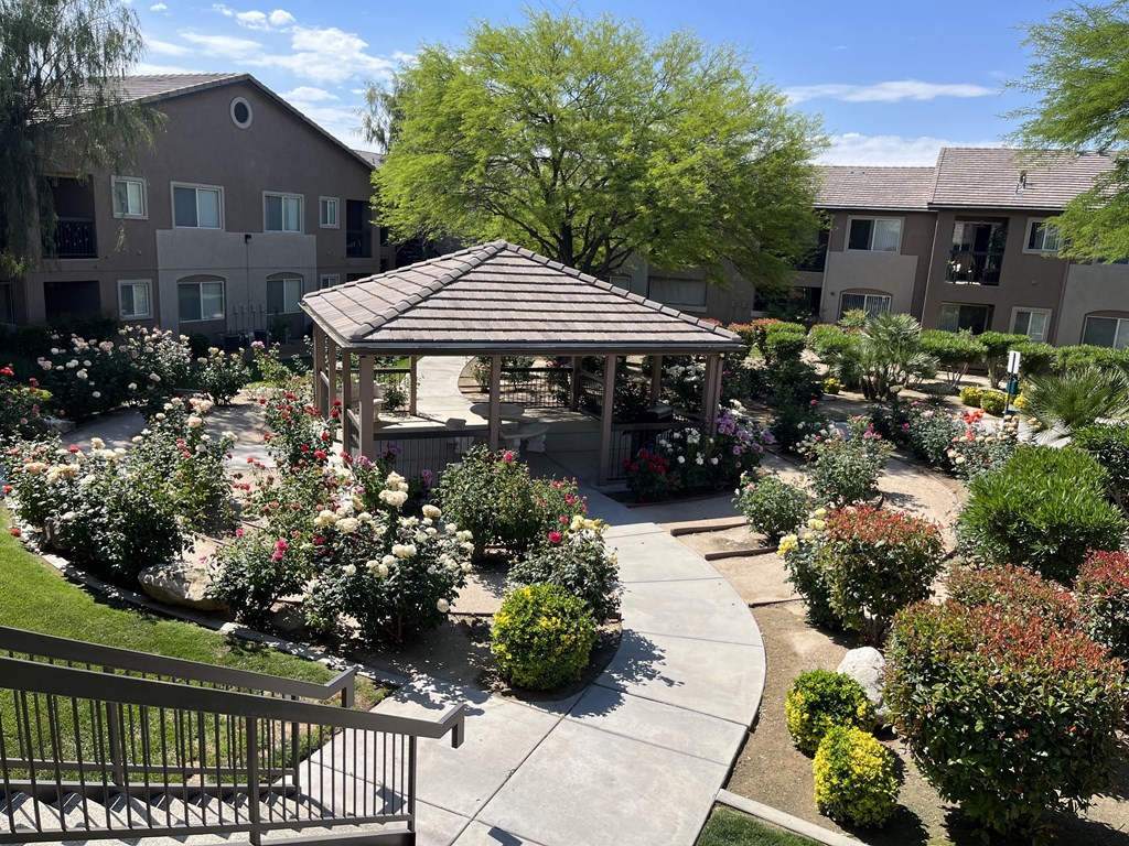 an aerial view of a garden area with a gazebo and landscaping