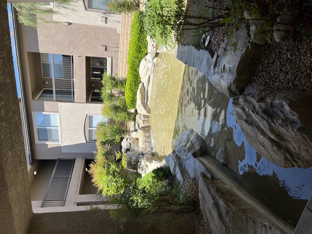 a view of a building and a waterfall from above