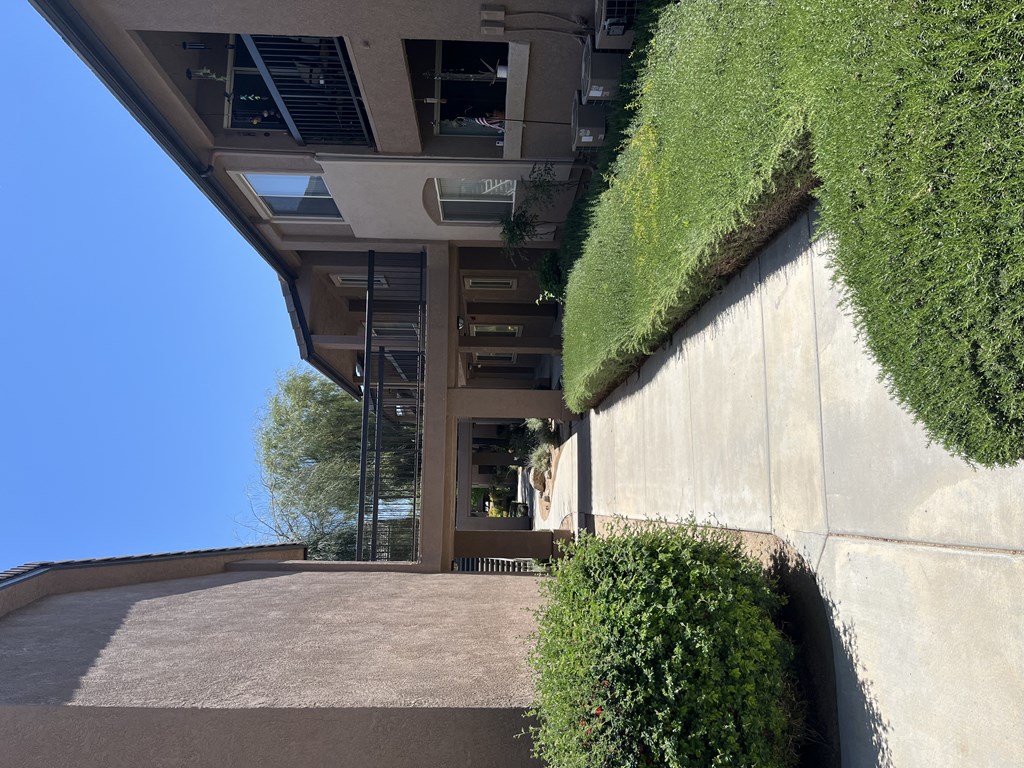 a view of the front of a building with a grass covered roof