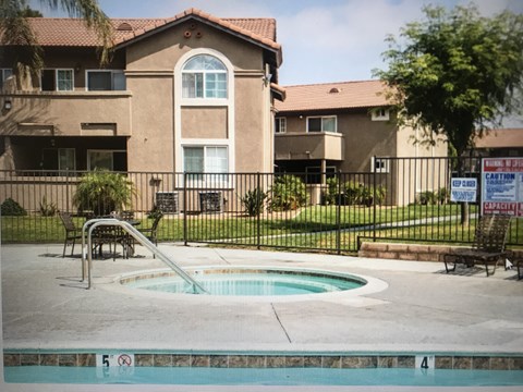 A pool with a slide in front of a building.
