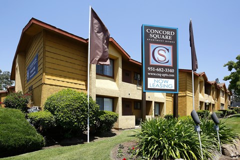 A building with a sign that says Concord Square Apartment Homes.