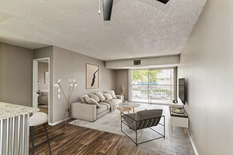 A living room with a couch, chair, and television.