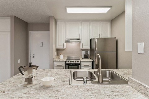 Kitchen with granite countertops and stainless steel appliances at Crystal View Apartments, California