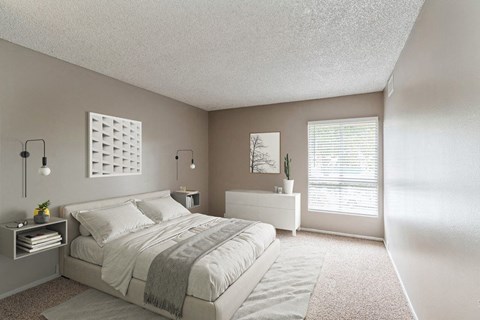A bedroom with a large bed and a window with blinds.