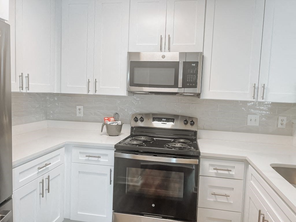 Renovated One-Bedroom Kitchen With White Shaker Cabinet Doors