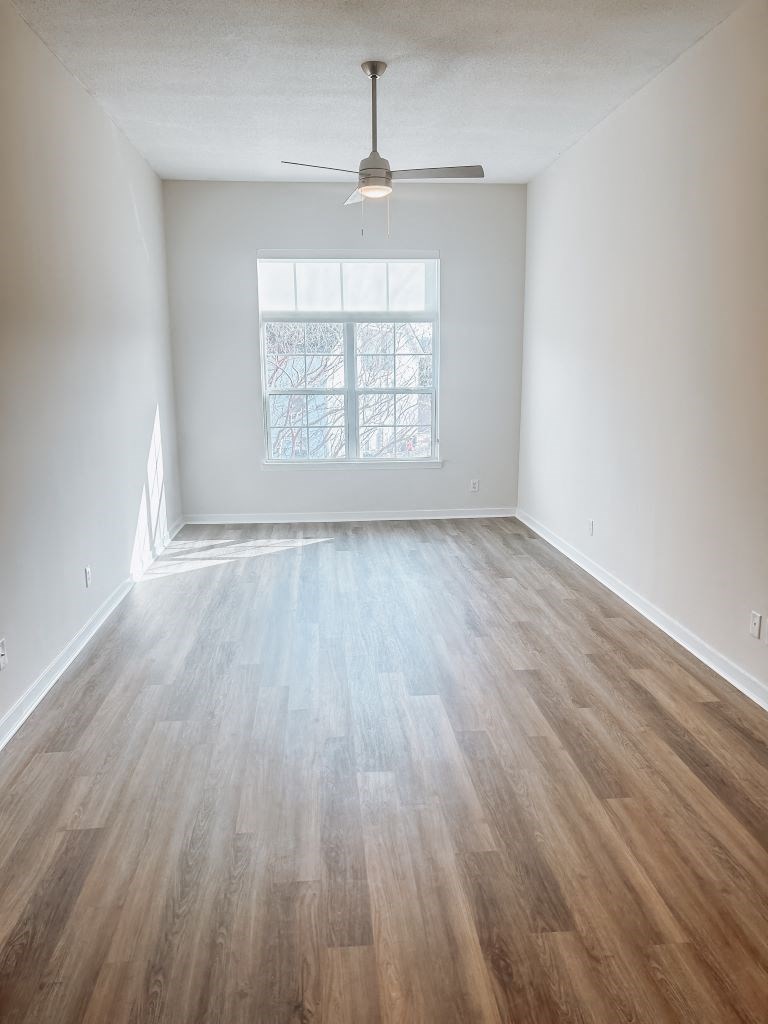 Renovated One-Bedroom Livingroom With New Window and Ceiling Fan