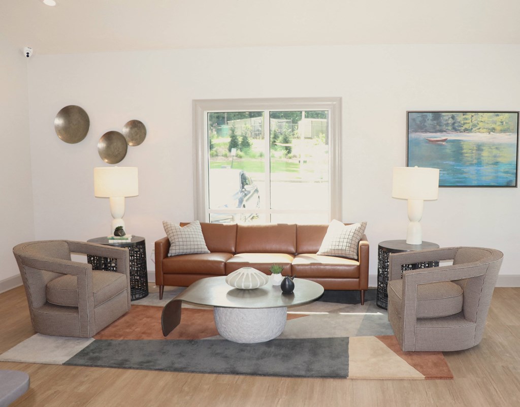 a living room with couches and chairs and a table  at Laurelwood Apartment Homes, Laurel, Mississippi, 39440