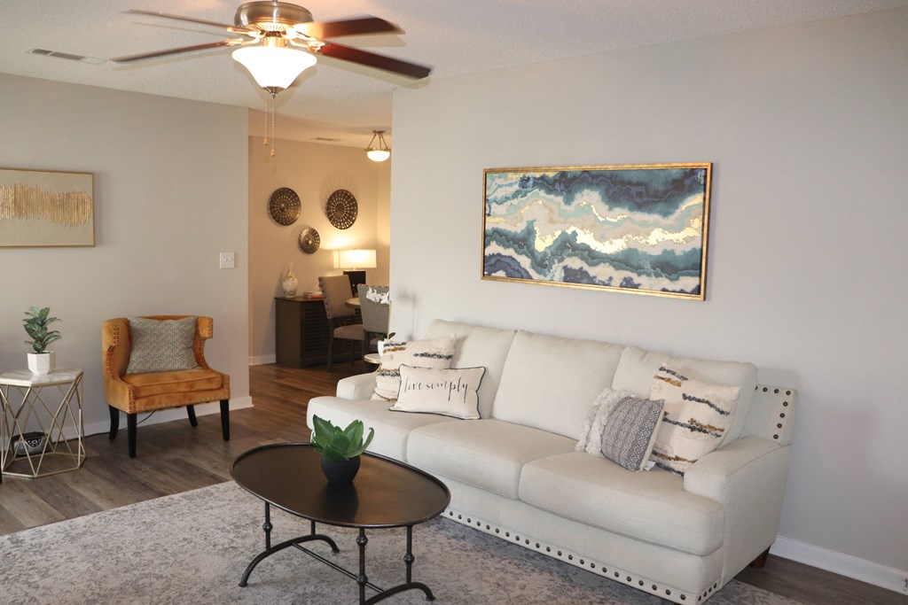a living room with a couch and a coffee table  at Laurelwood Apartment Homes, 39440