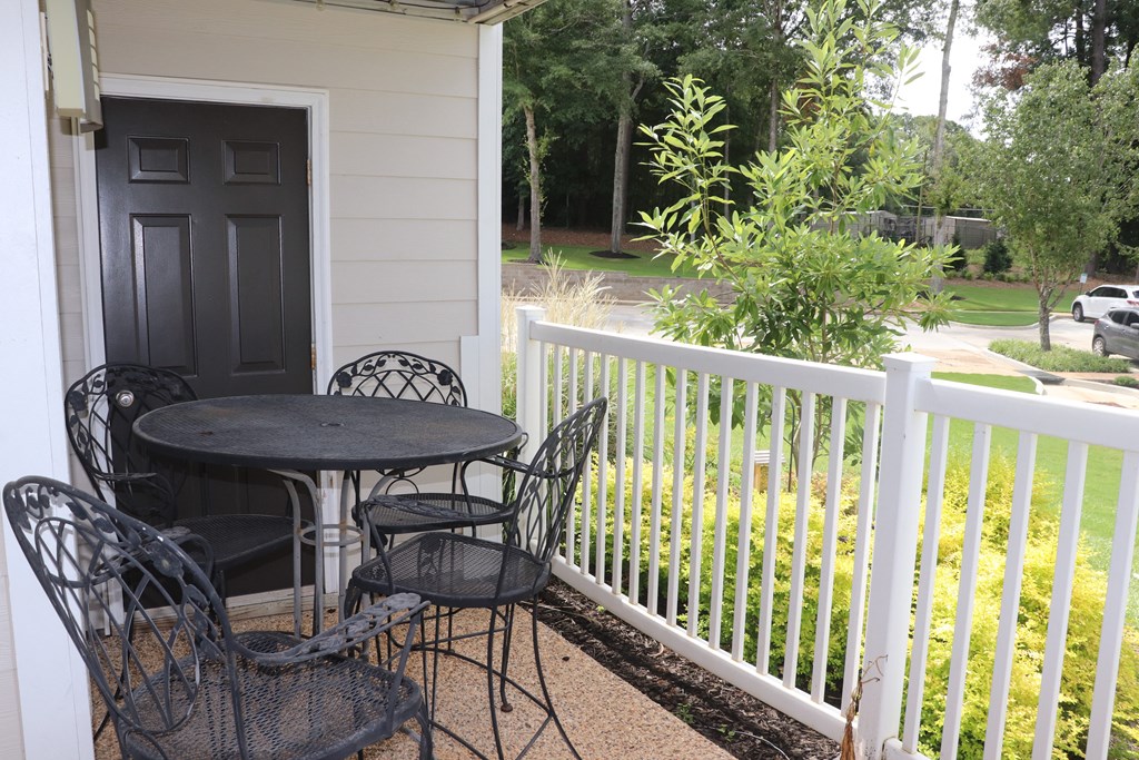 a patio with a table and chairs on a porch  at Laurelwood Apartment Homes, Laurel, Mississippi, 39440
