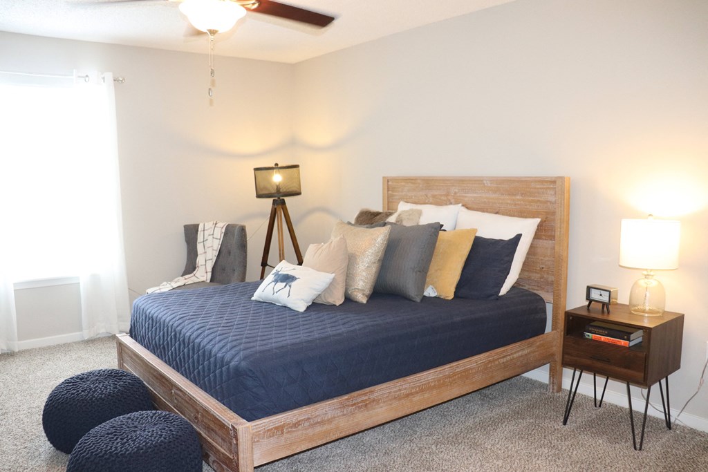 a bedroom with a bed and a ceiling fan  at Laurelwood Apartment Homes, Laurel, Mississippi