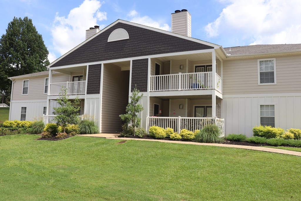 the view of a house with a porch and a lawn  at Laurelwood Apartment Homes, Mississippi