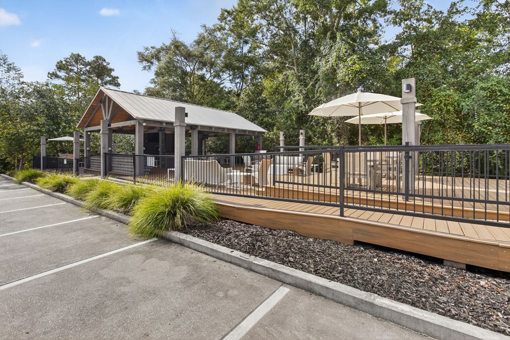 A parking lot with a gazebo and a fence.