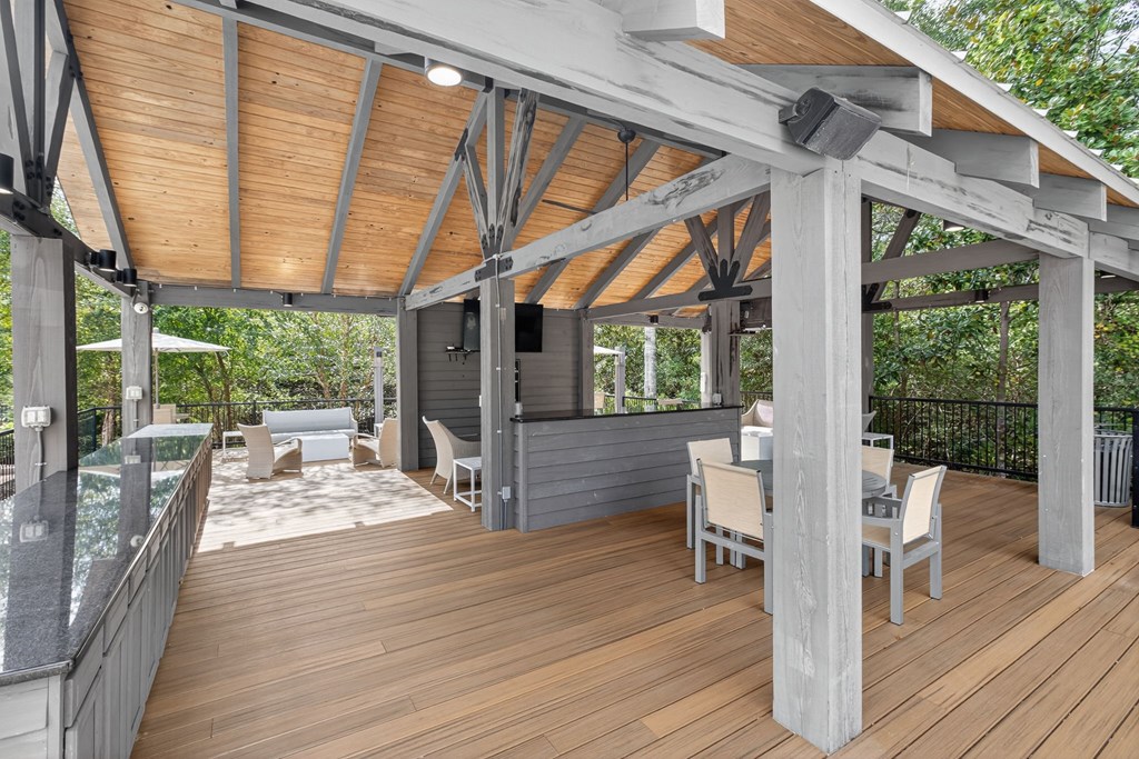 A wooden deck with a table and chairs.
