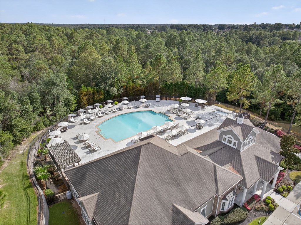 A large house with a pool and a hot tub.