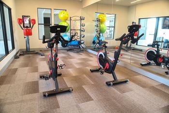 A gym with exercise bikes and other equipment at The Azul Apartment Homes in Oxford, MS