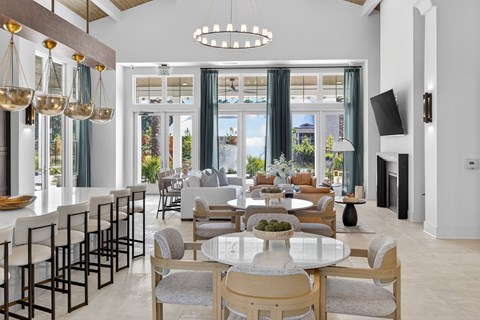 A modern dining room with a large table and chairs at Saltaire Apartment Homes in Santa Rosa Beach, FL