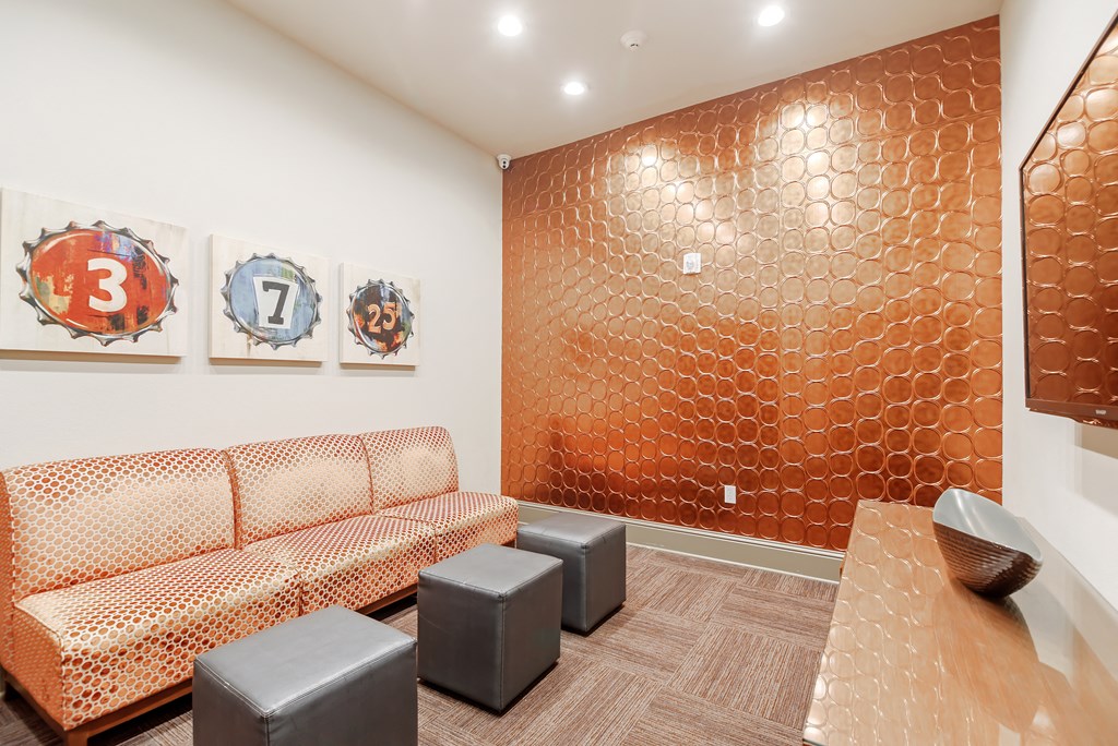 a room with couches and a table and paintings on the wall at Cumberland Place Apartment Homes, Tyler