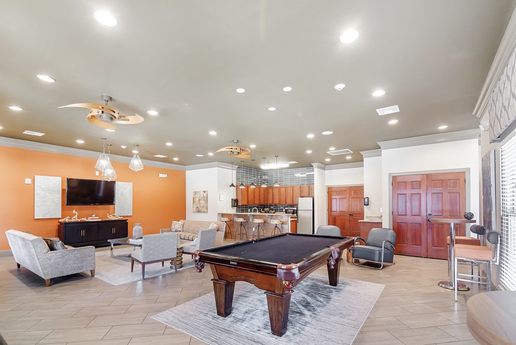 a game room with a pool table and a bar at Cumberland Place Apartment Homes, Tyler, TX 75703