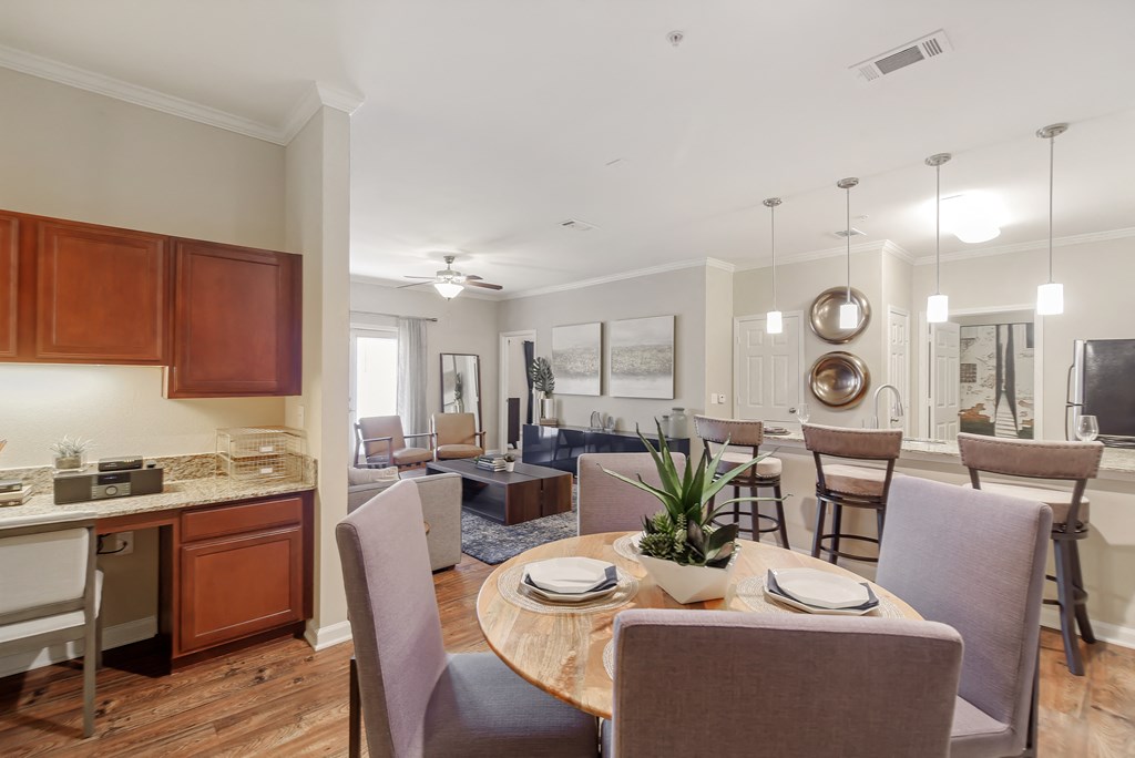 a living room and dining room with a table and chairs at Cumberland Place Apartment Homes, Tyler