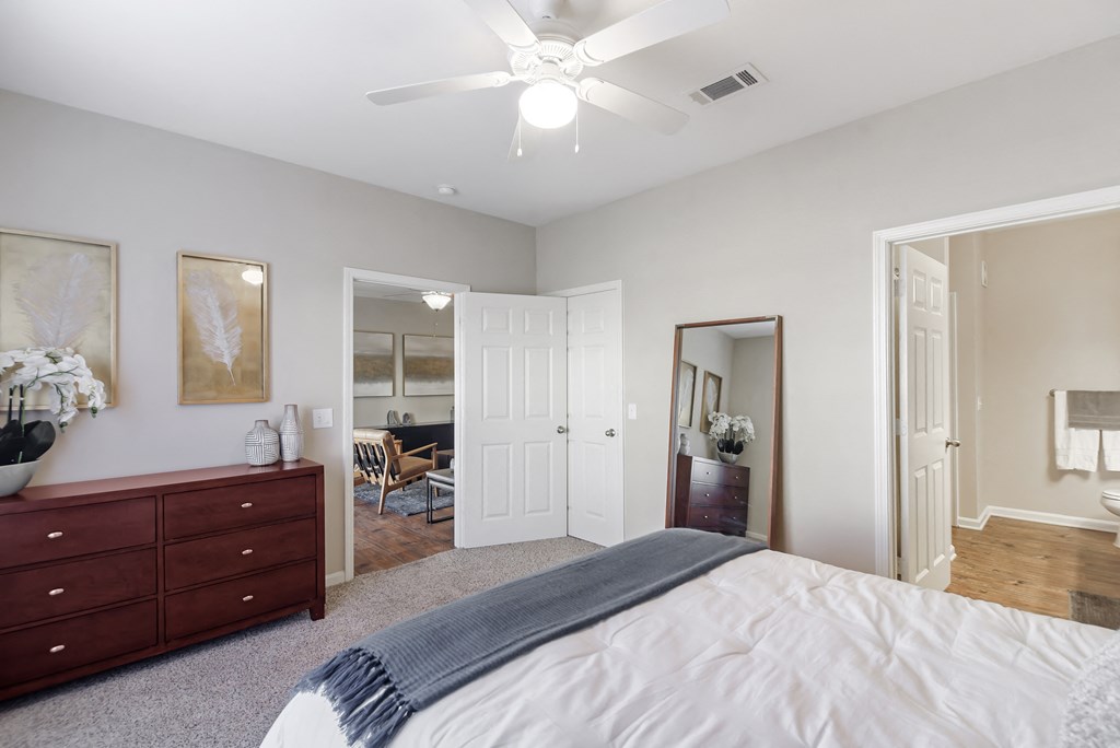 a bedroom with a large bed and a ceiling fan at Cumberland Place Apartment Homes, Tyler 75703