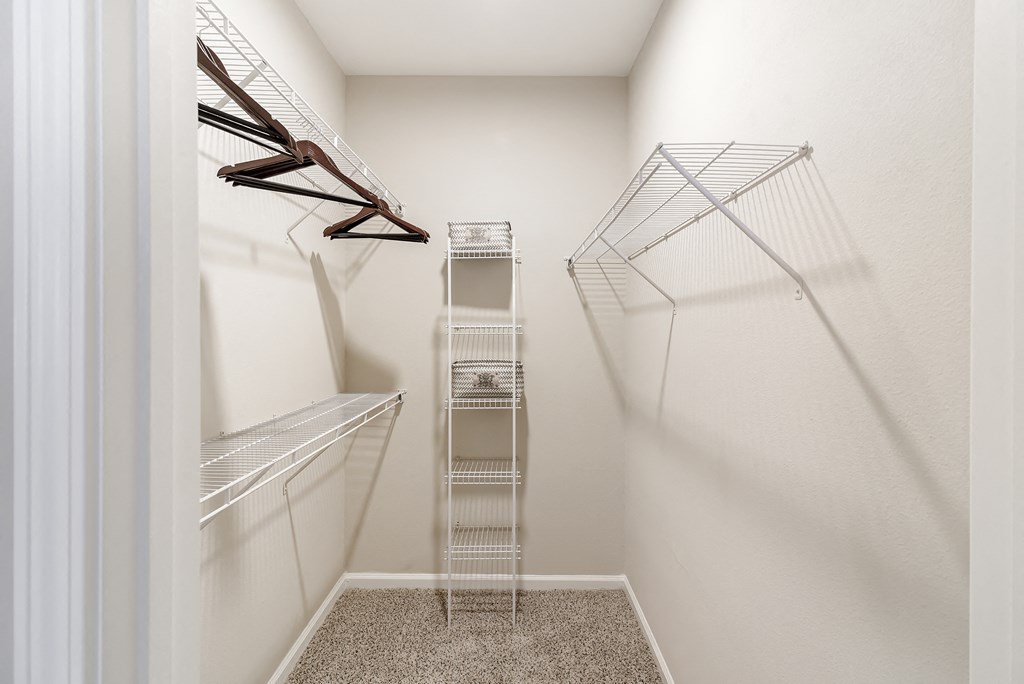 a spacious walk in closet with white walls at Cumberland Place Apartment Homes, Tyler, Texas
