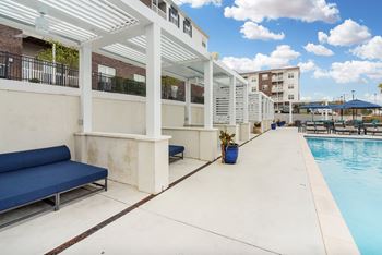 A pool area with a cabanas at The Met Apartment Homes, Hattiesburg, MS