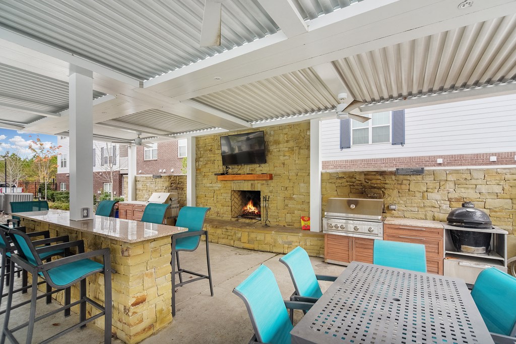 Patio with Stone Fireplace at The Met Apartment Homes, Hattiesburg, Mississippi